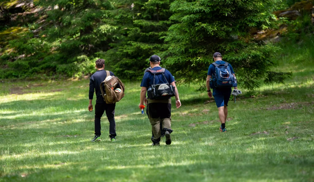 Colleagues at a company event playing disc golf